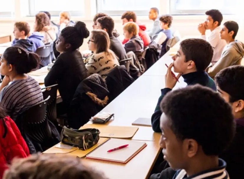 A group of participants sat at desks taking part in a workshop