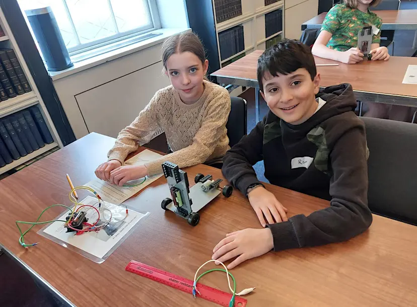 Two children participating in the electronic and electrical control workshop