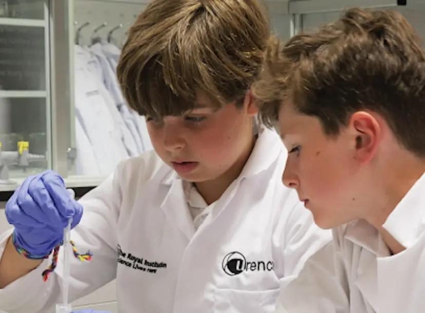 Participants at a workshop wearing lab coats