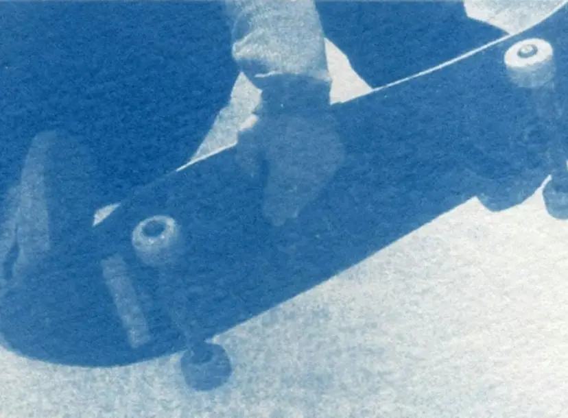 someone holding on to a skateboard with their hands and feet