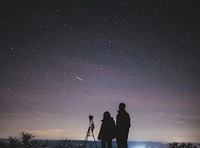 Two people against a backdrop of the starry night sky