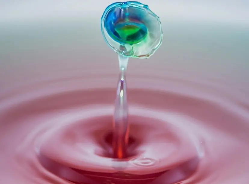 A droplet of water rippling from the surface 