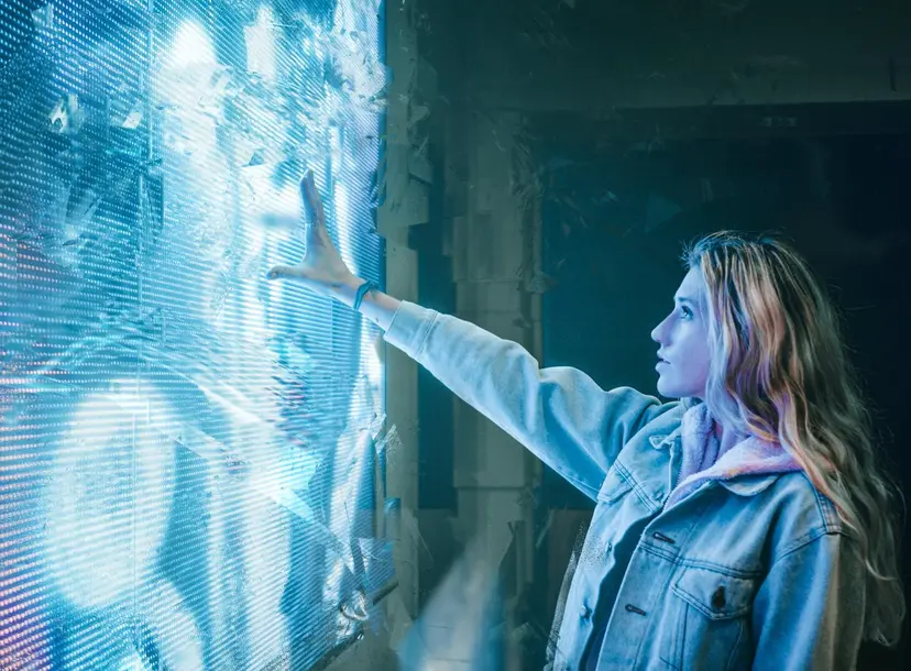 A women infront of a blue LED screen