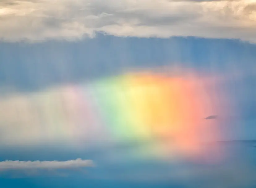 Rainbow in between the clouds