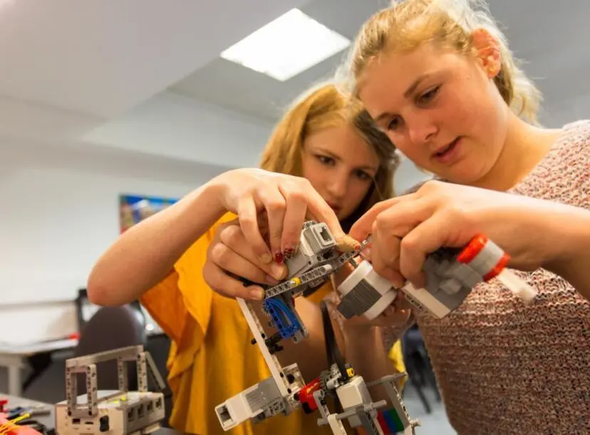 Participants working on a small LEGO Mars rover