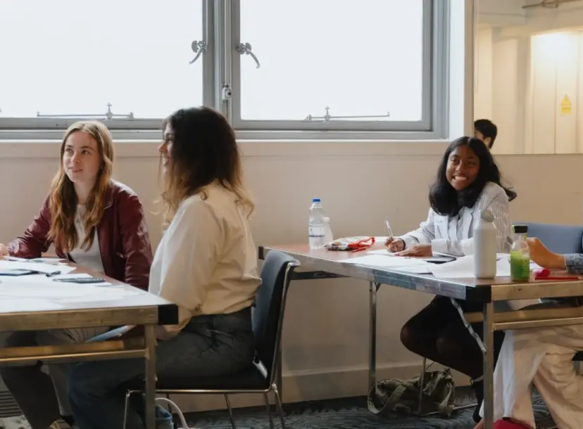 Participants sat at a desk in a workshop