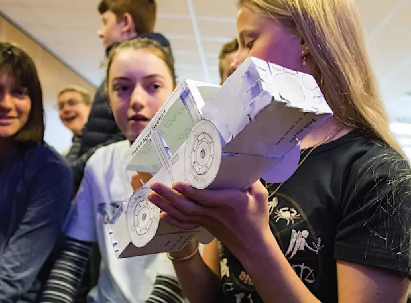 Children holding paper car