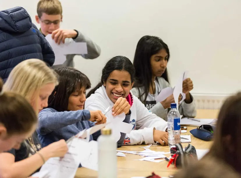 Participants sat at a desk in a workshop