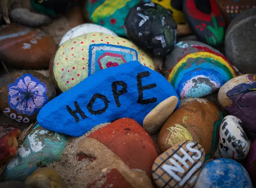 Painted pebbles with the words NHS, hope and 2020