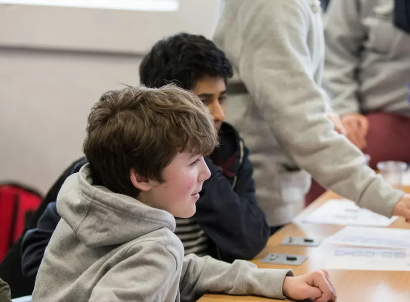 Participants sat at a desk in a workshop