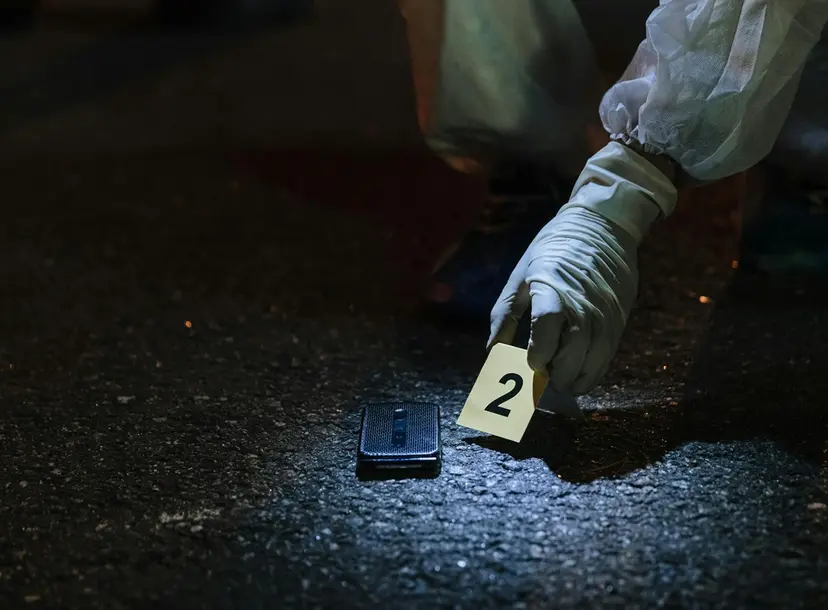 CSI gloved hand on scene of crime
