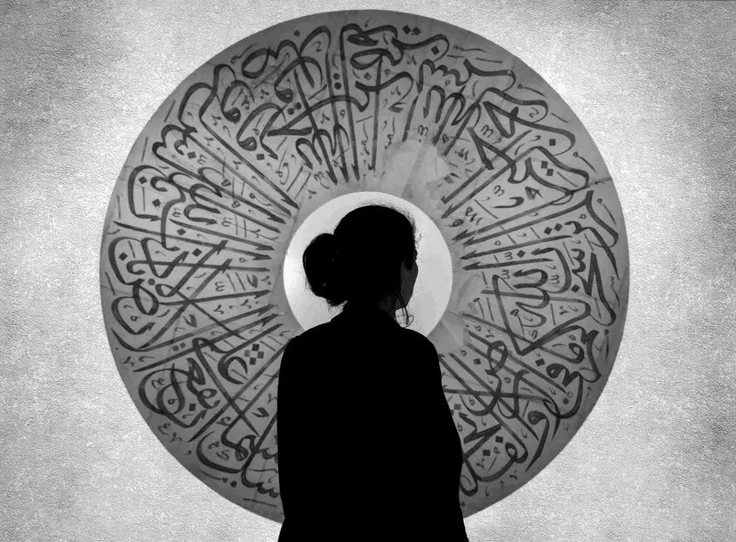 Silhouette of a woman against a round arabic ornament
