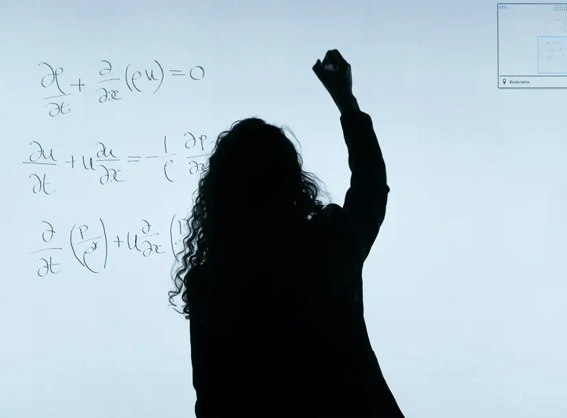 A shadow writes on board