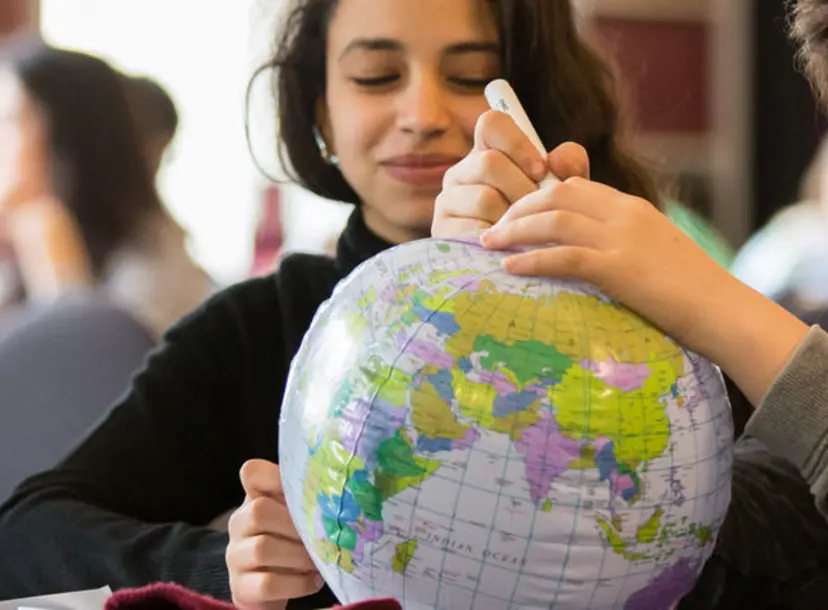 Children are playing with a inflatable globe
