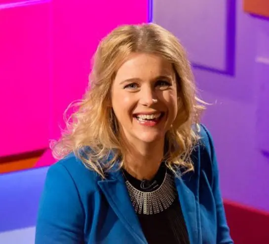 Danielle George smiling, in front of  a colourful backdrop