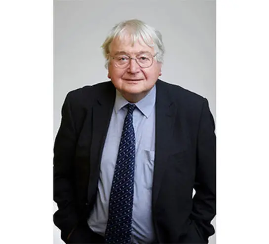 Sir Richard Catlow, he has grey hair, glasses and wears a dark suit with a blue patterned tie 