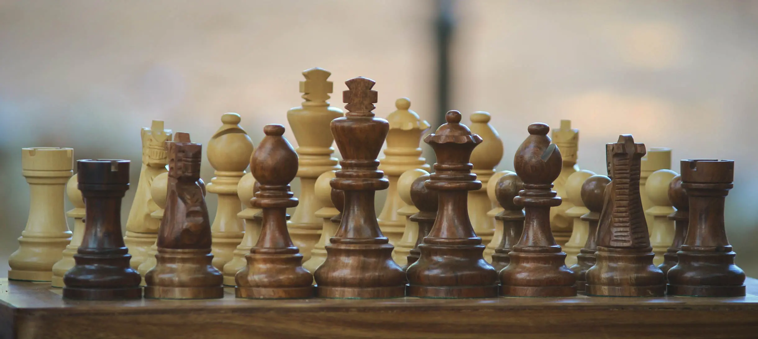 chess board with chess pieces made out of wood
