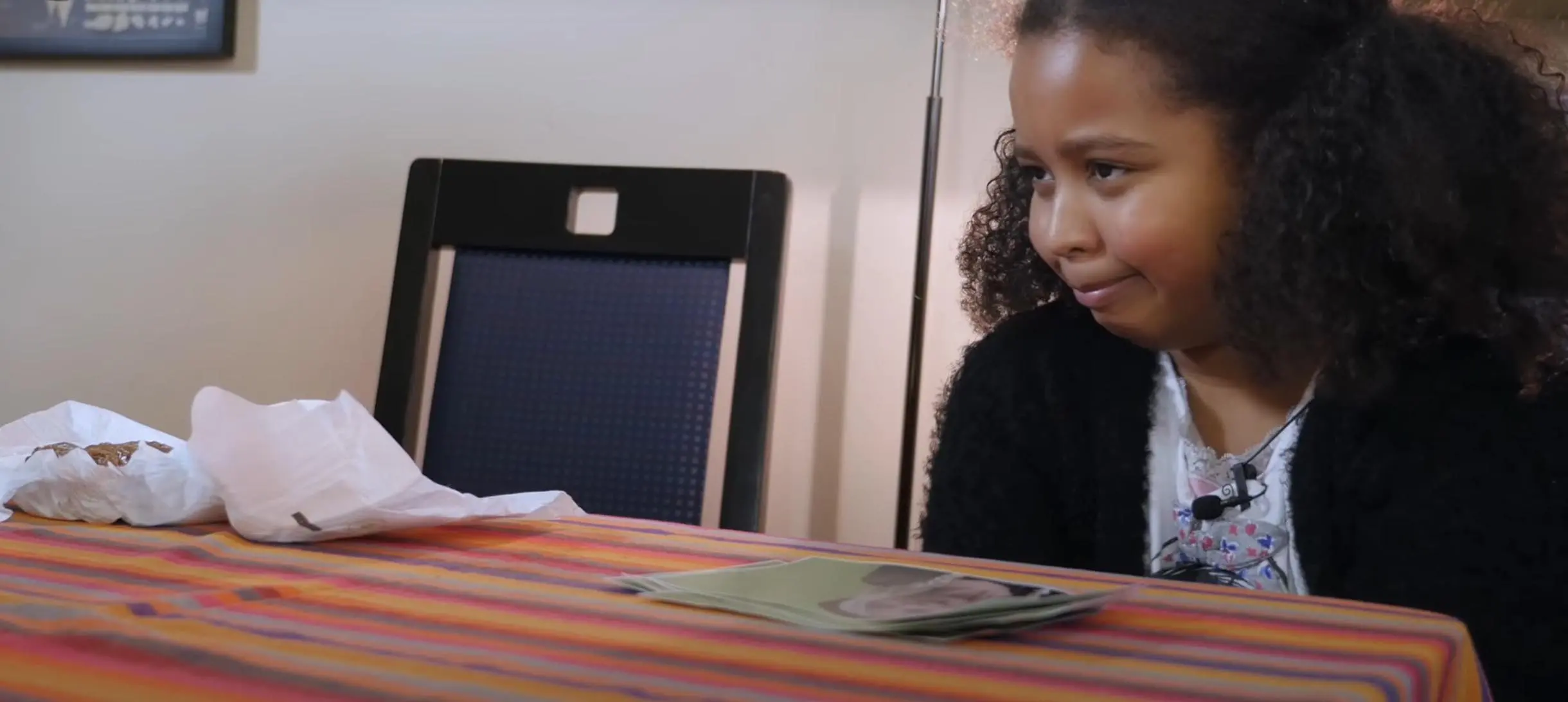 young girl looks at a diaper in disgust