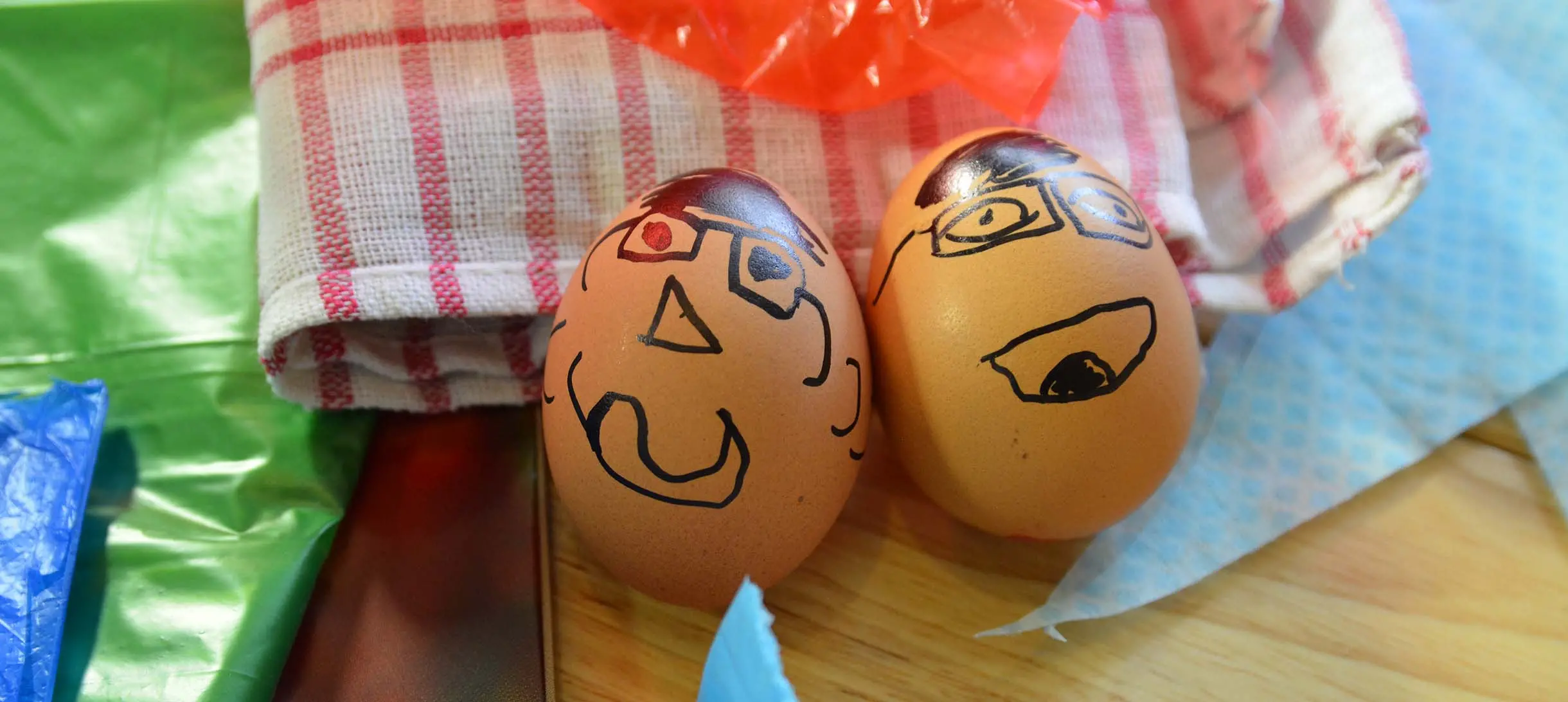 two eggs with faces drawn on them