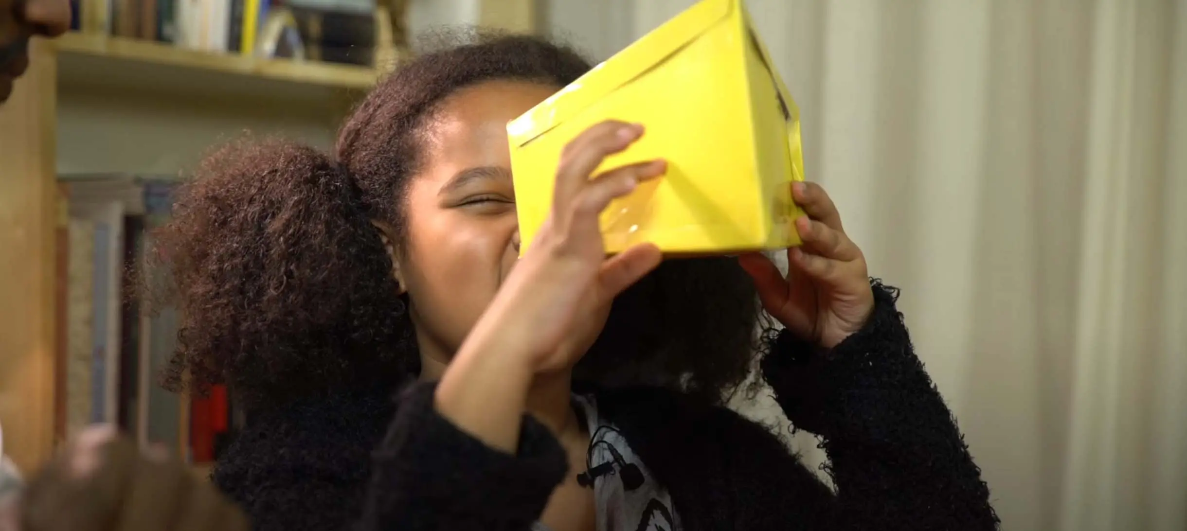 a girl looking into a cardboard box