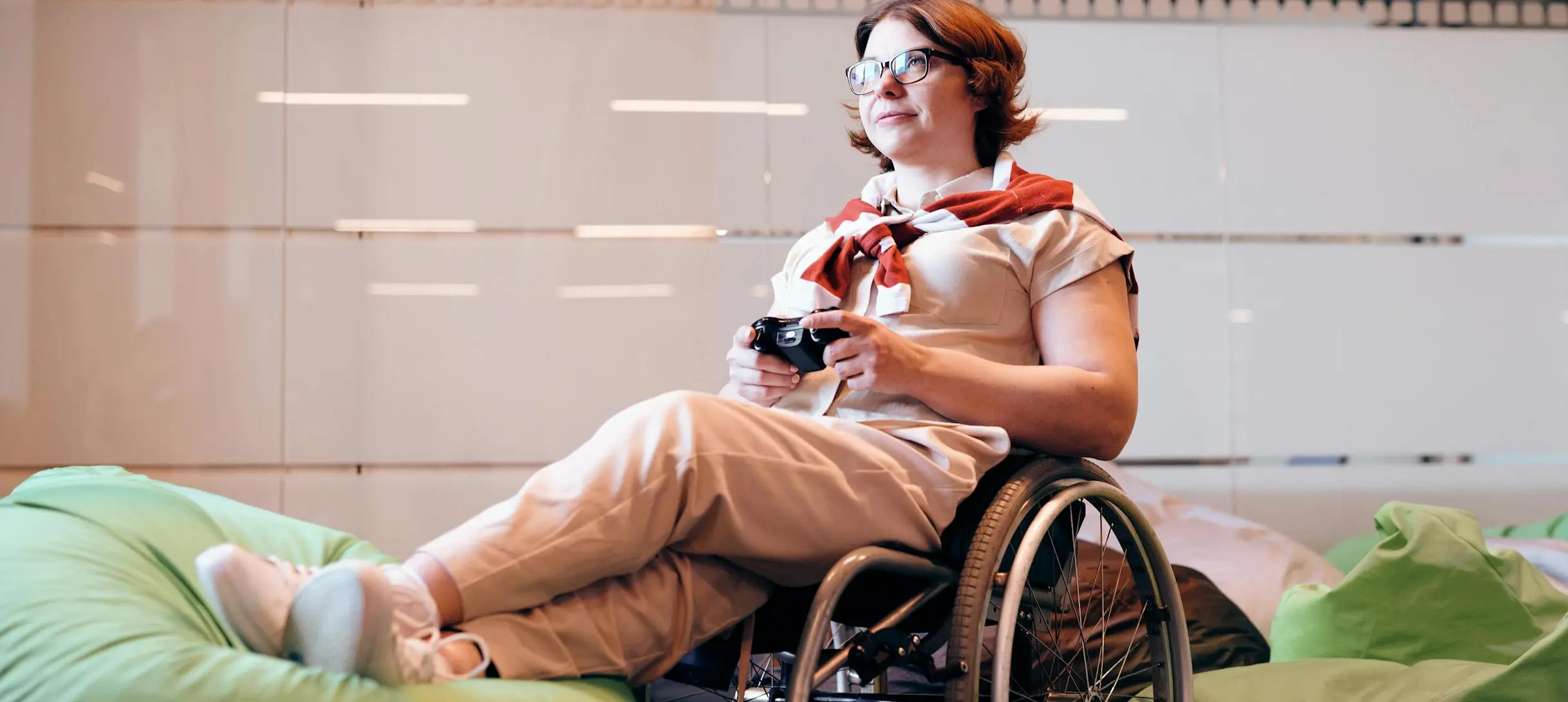 Woman Sitting on Black Wheelchair While Holding Game Controller