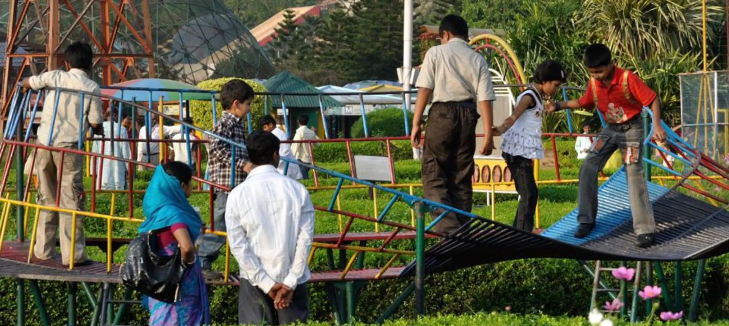 children playing on a playground that is shaped like a mobius band