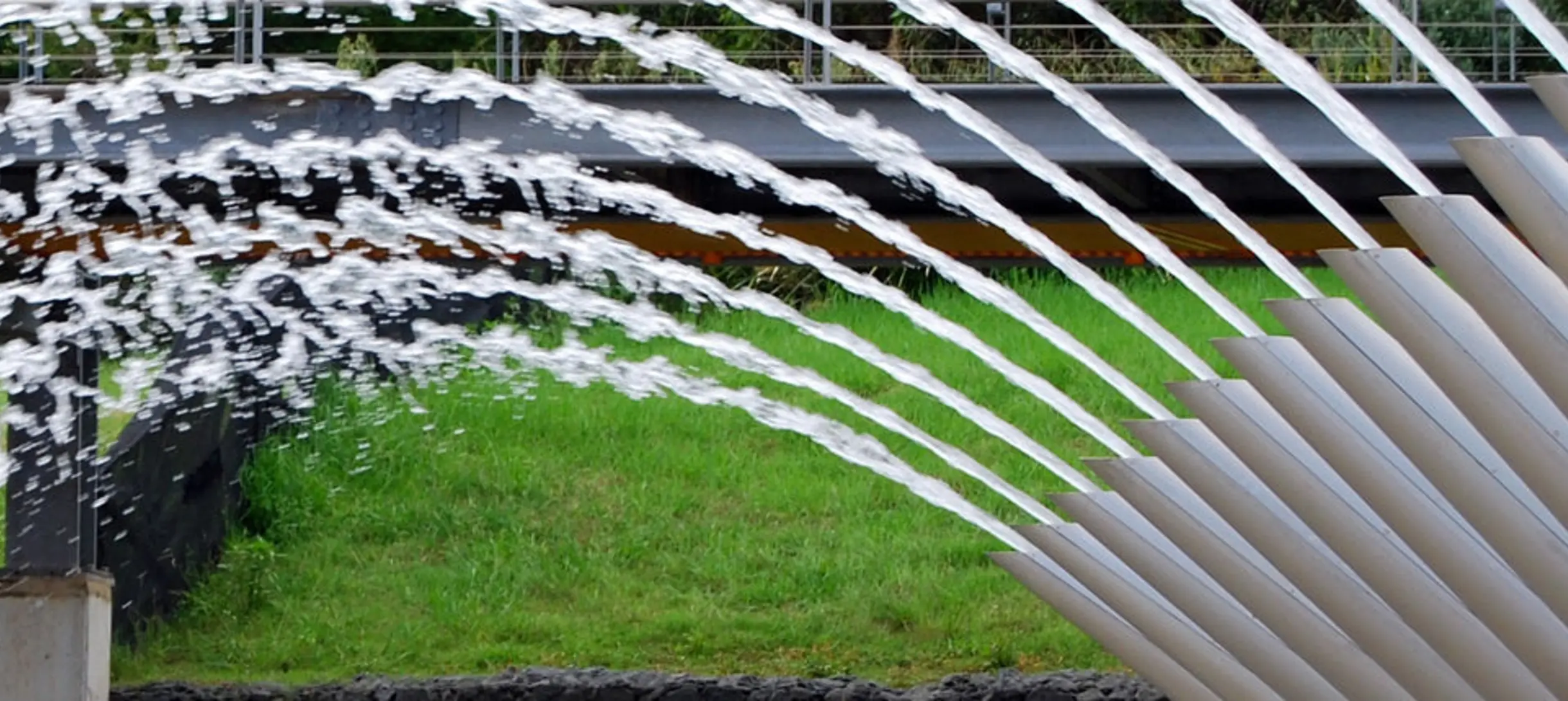 water fountain with curved spouts where water comes out in symmetrical arcs from each spout