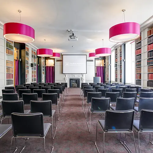 rows of chairs facing a projector screen