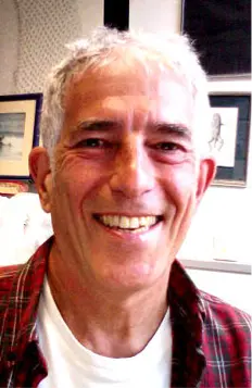 A similing white man with short grey hair