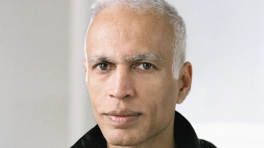 Manil suri is looking at the camera