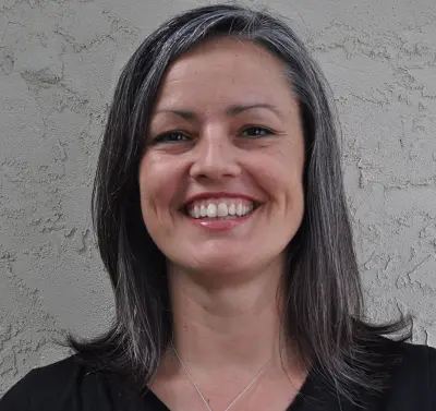 a woman is smiling towards the camera
