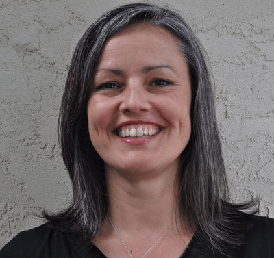 a woman is smiling towards the camera