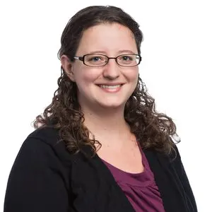 a woman is smiling at the camera