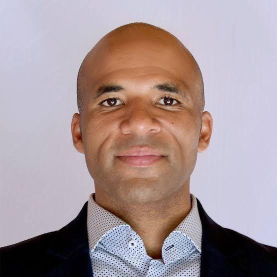 A man is smiling at the camera.