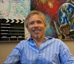 A man is smiling towards the camera.