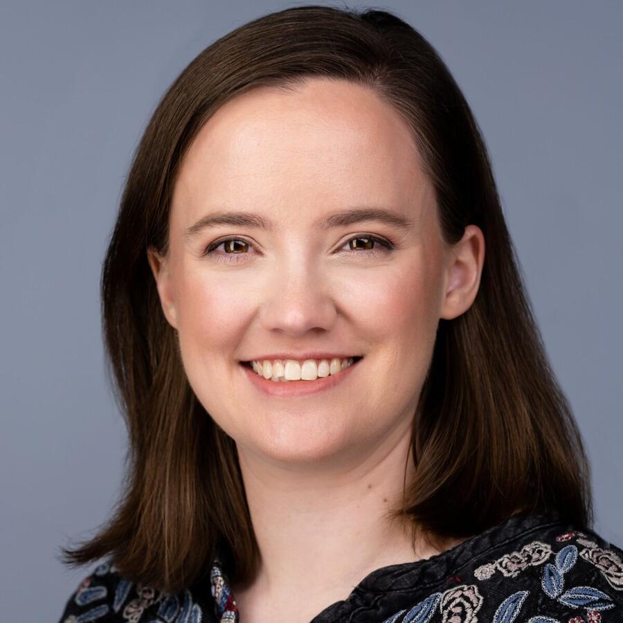 A woman is smiling towards the camera.