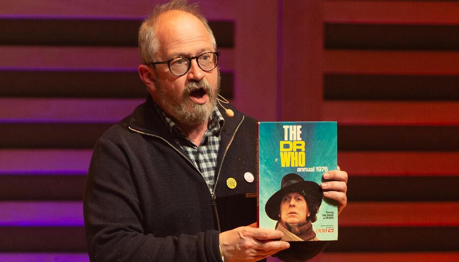 a man stands with book