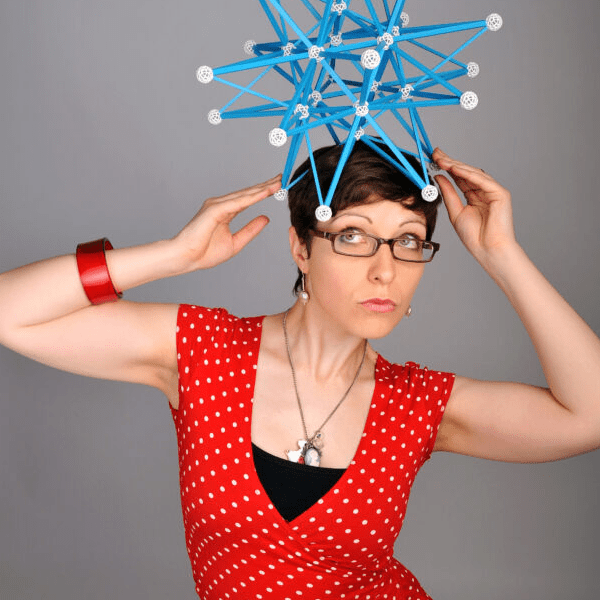 A woman is posing with an object on her head.