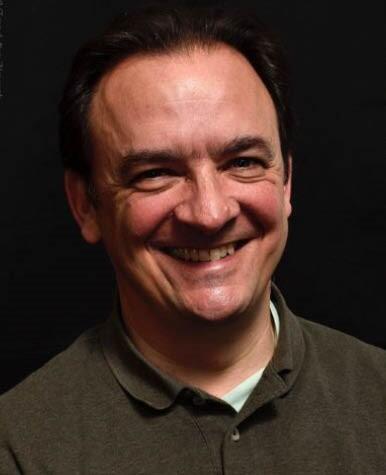 A man is smiling at the camera.