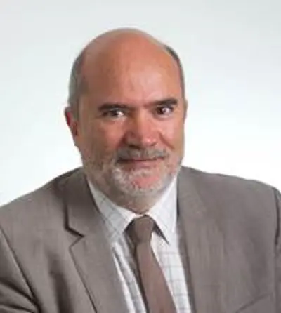 A man is smiling at the camera