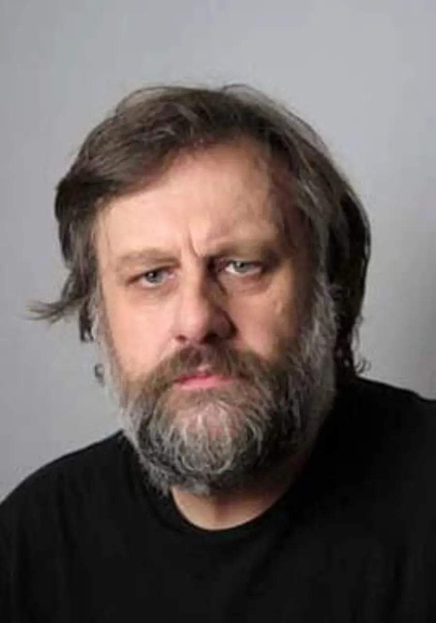 A man with a beard is looking at the camera