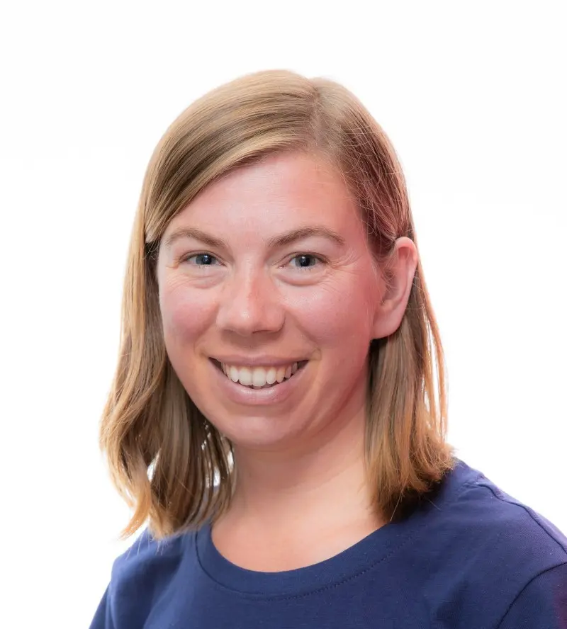 a woman is smiling towards the camera