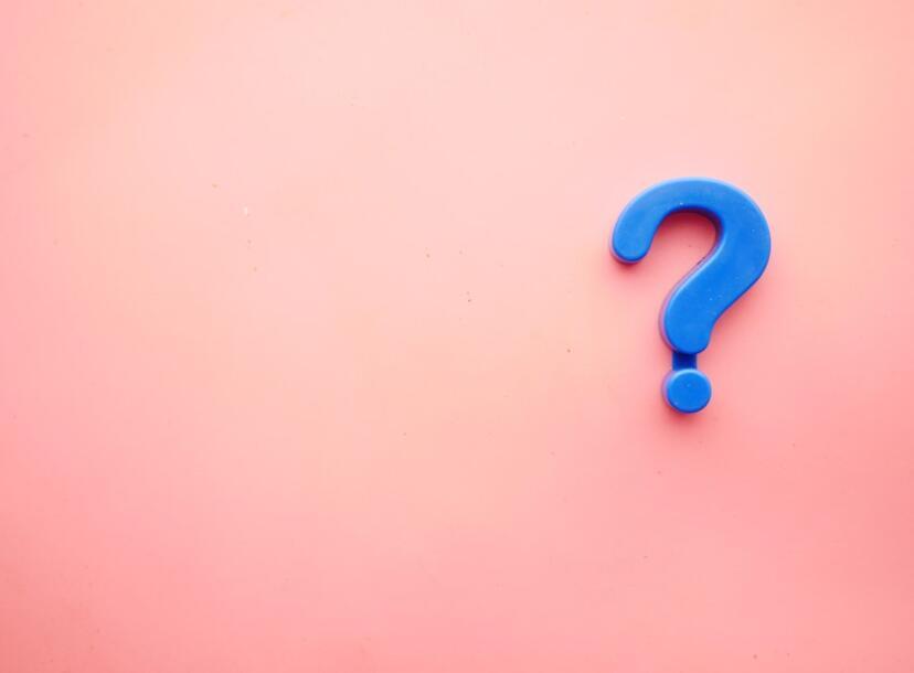 Blue question mark over a pink background