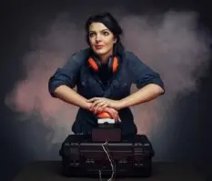 a woman is holding down a red button