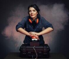 a woman is holding down a red button