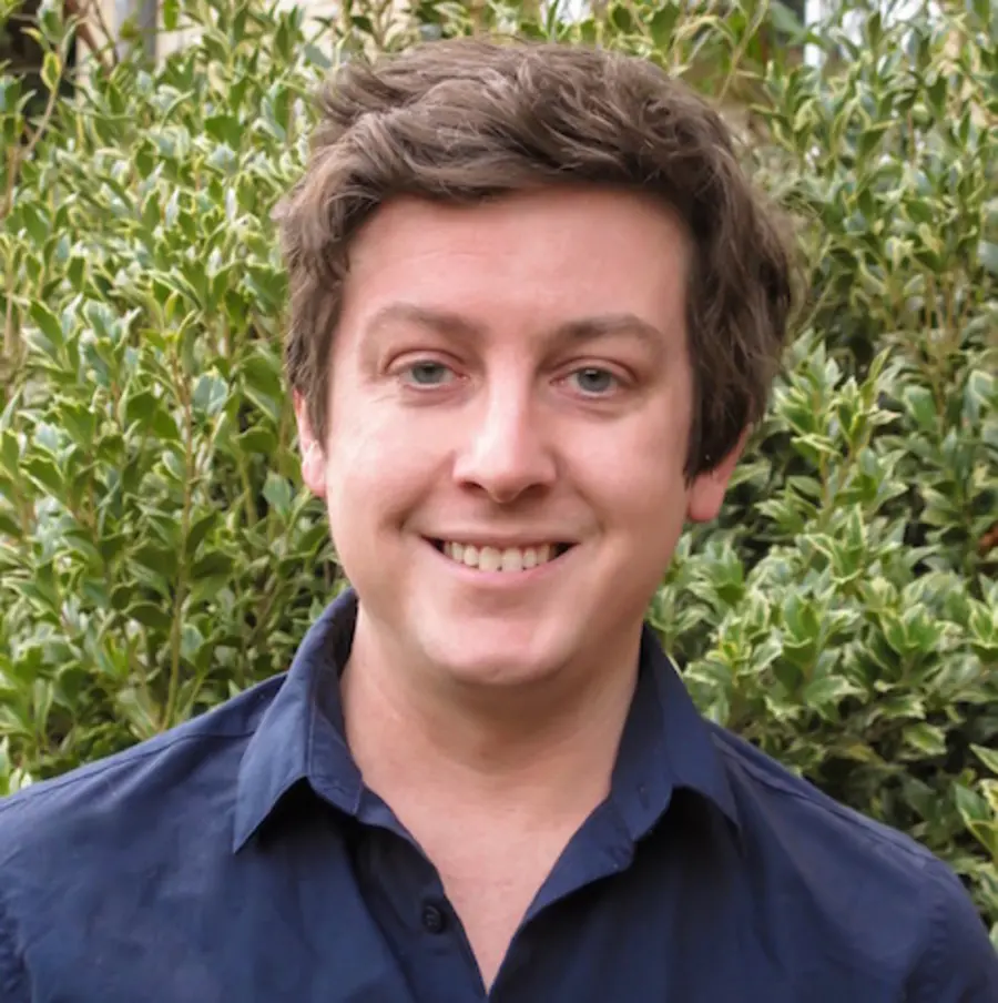 a man is smiling at the camera