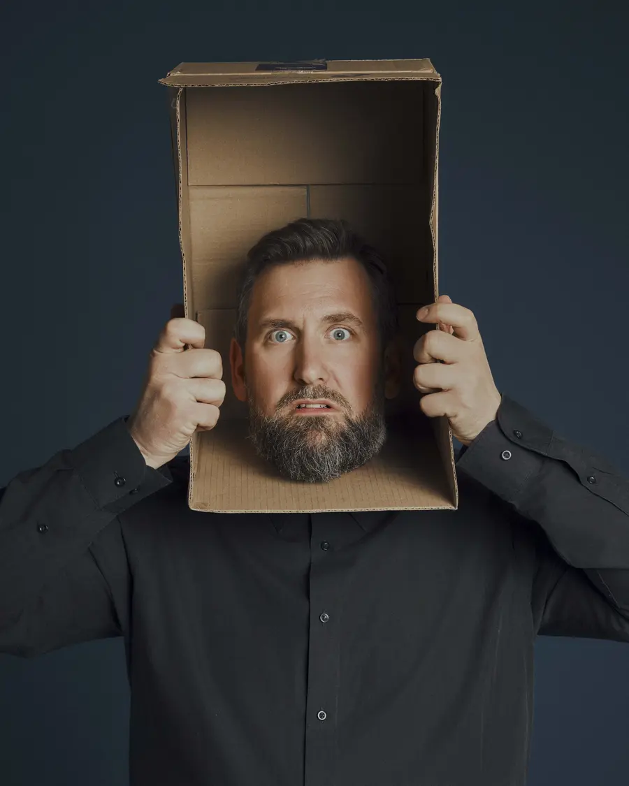 Garrett Millerick with his head in a box