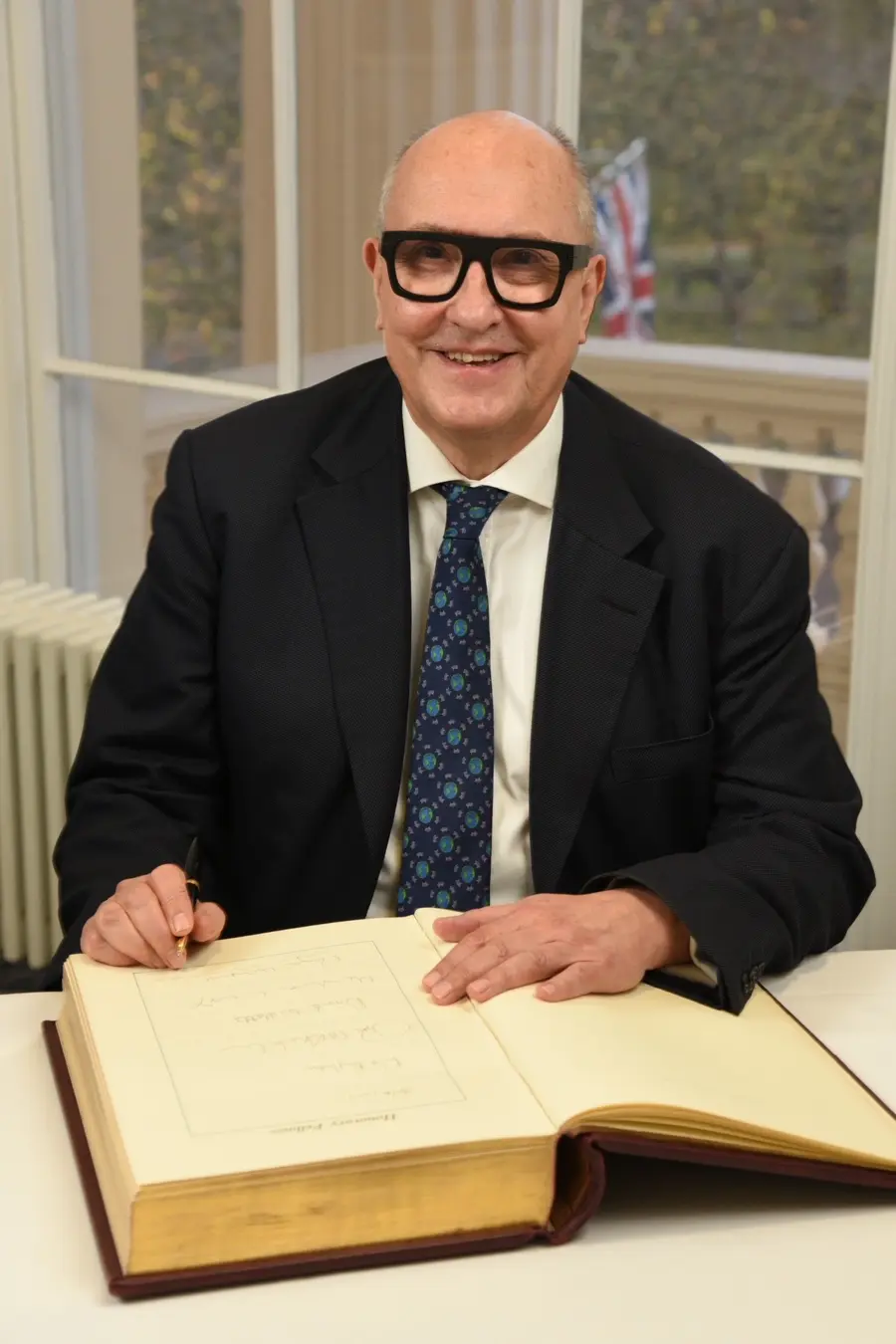 Roger Highfield sat with a large book
