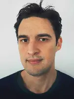 An image of Daniel Baumann looking at the camera
