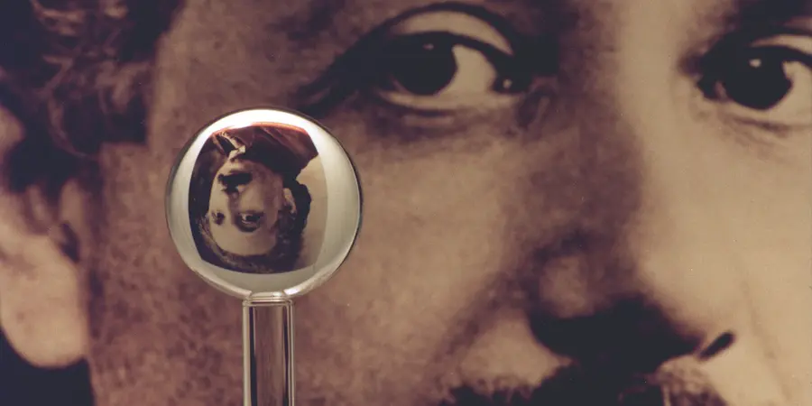 One of Gravity Probe B's gyroscopes pictured refracting the image of Albert Einstein in background.